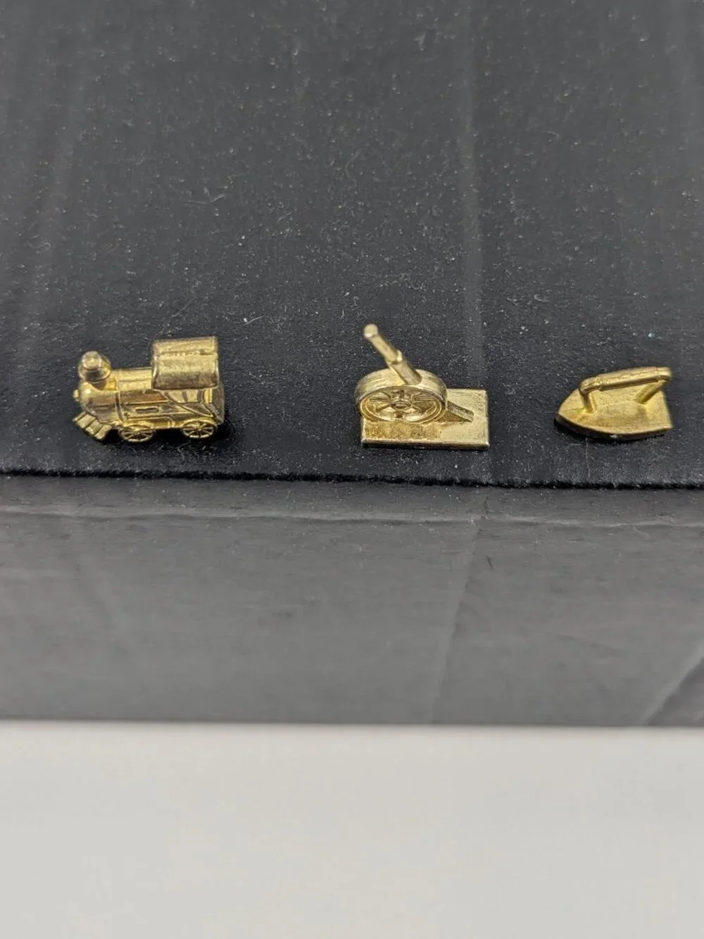 Three gold color monopoly replacement pieces train, canon, iron